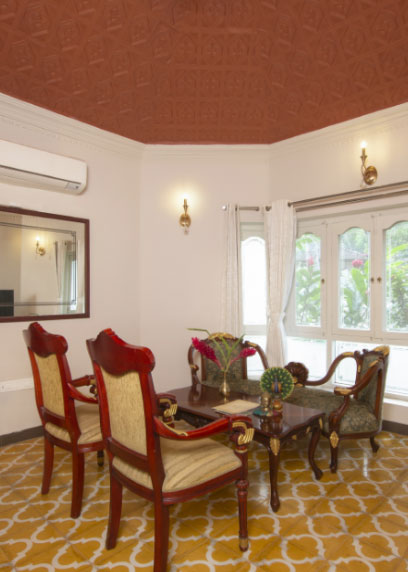 Sip a cup of herbal tea at the sitting area and enjoy the picturesque from the window | Kairali-The Ayurvedic Healing Village